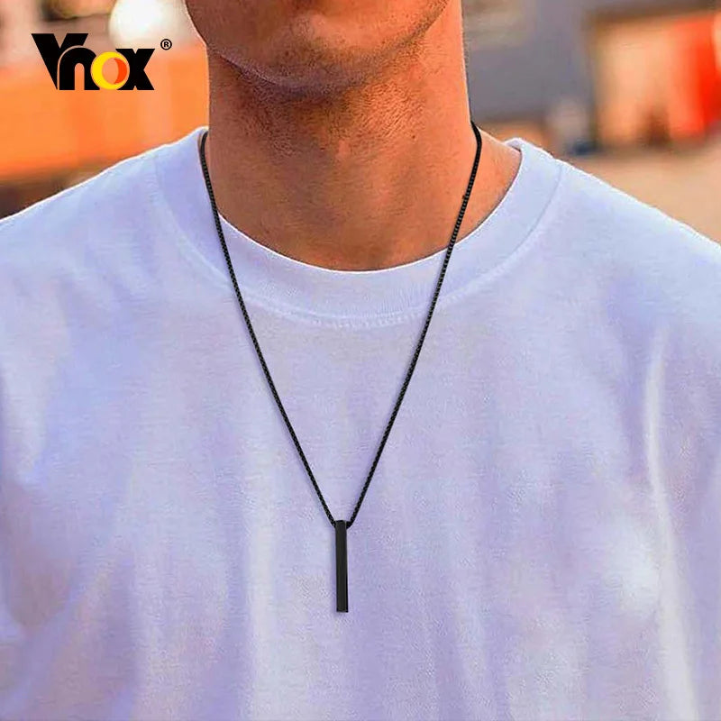 Man wearing black pendant necklace with white t-shirt, close-up lifestyle photo