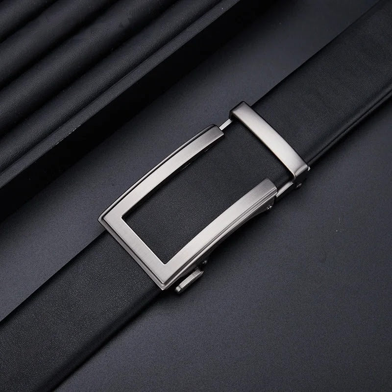Slim low-profile buckle close-up on black leather ratchet belt